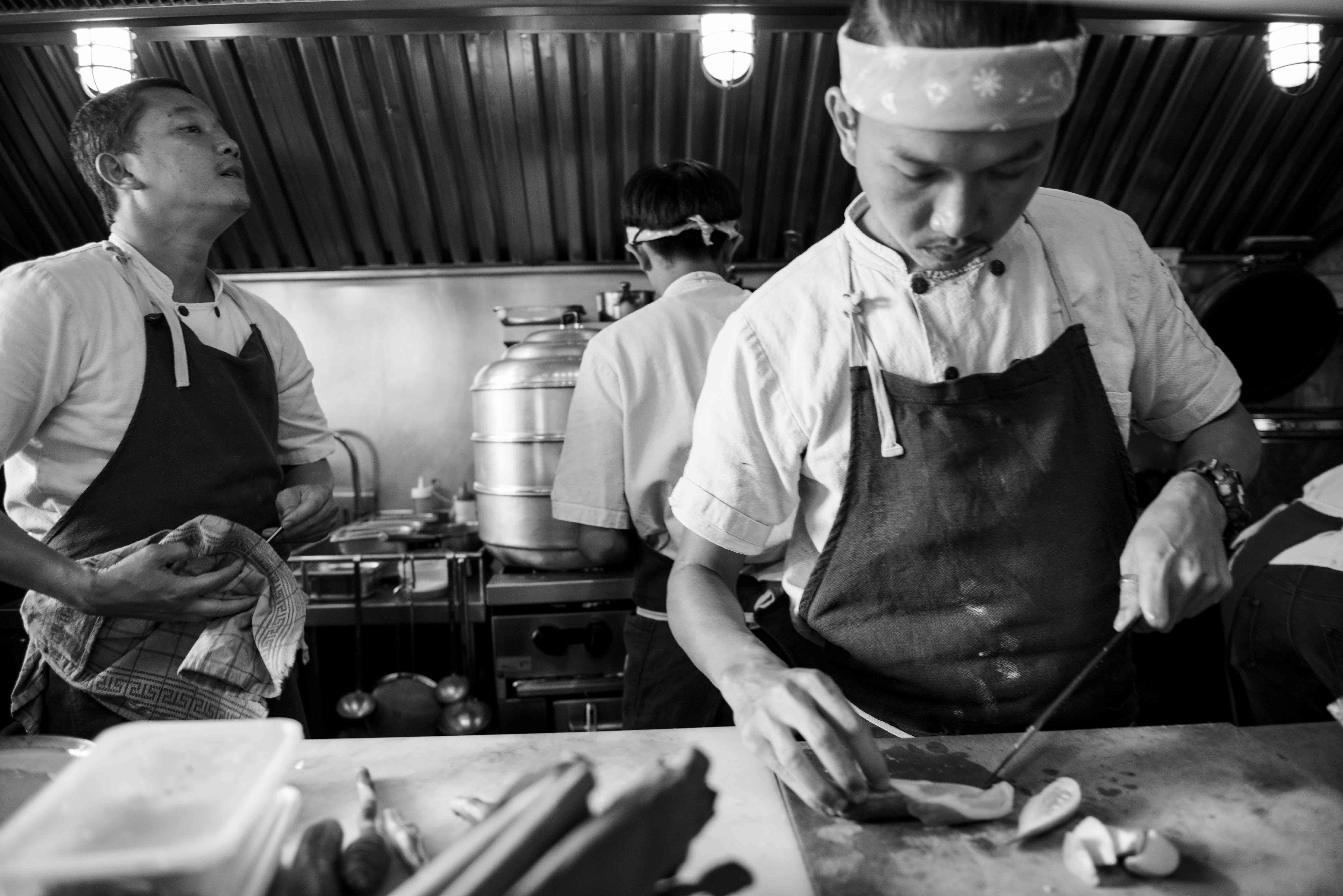 Editorial documentary — chefs at work in a Thai restaurant kitchen during service