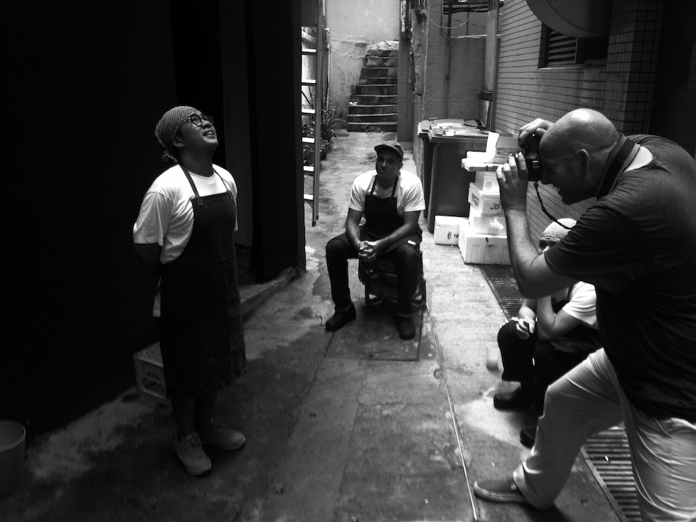 Jason Michael Lang on assignment in a Bangkok back alley, photographing a young chef