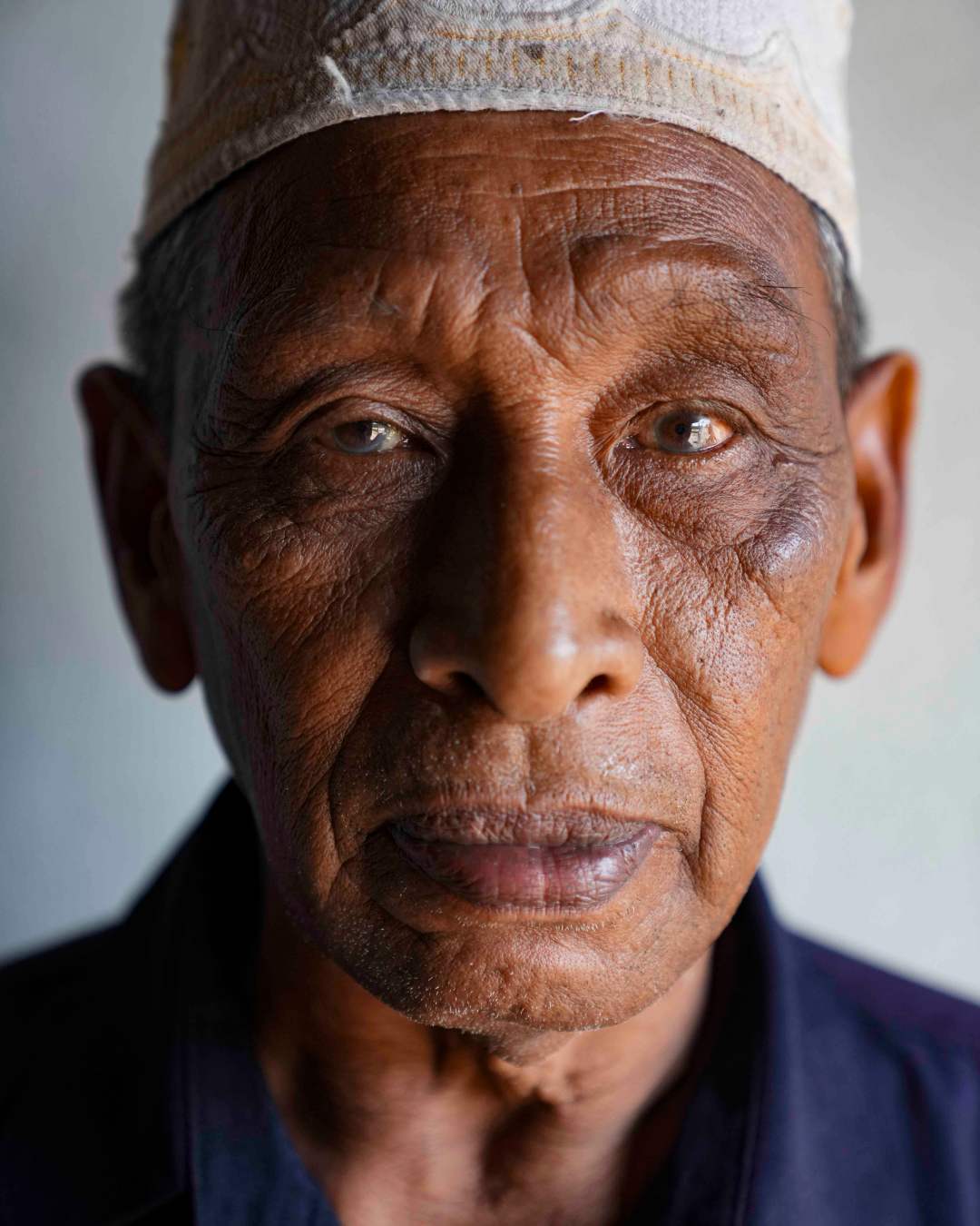 Editorial portrait of an elderly Muslim man in a kufi cap, Pattani, Southern Thailand